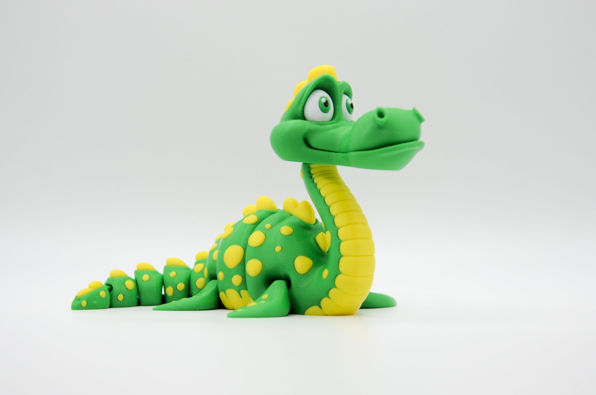 Green spotted articulated dragon side view