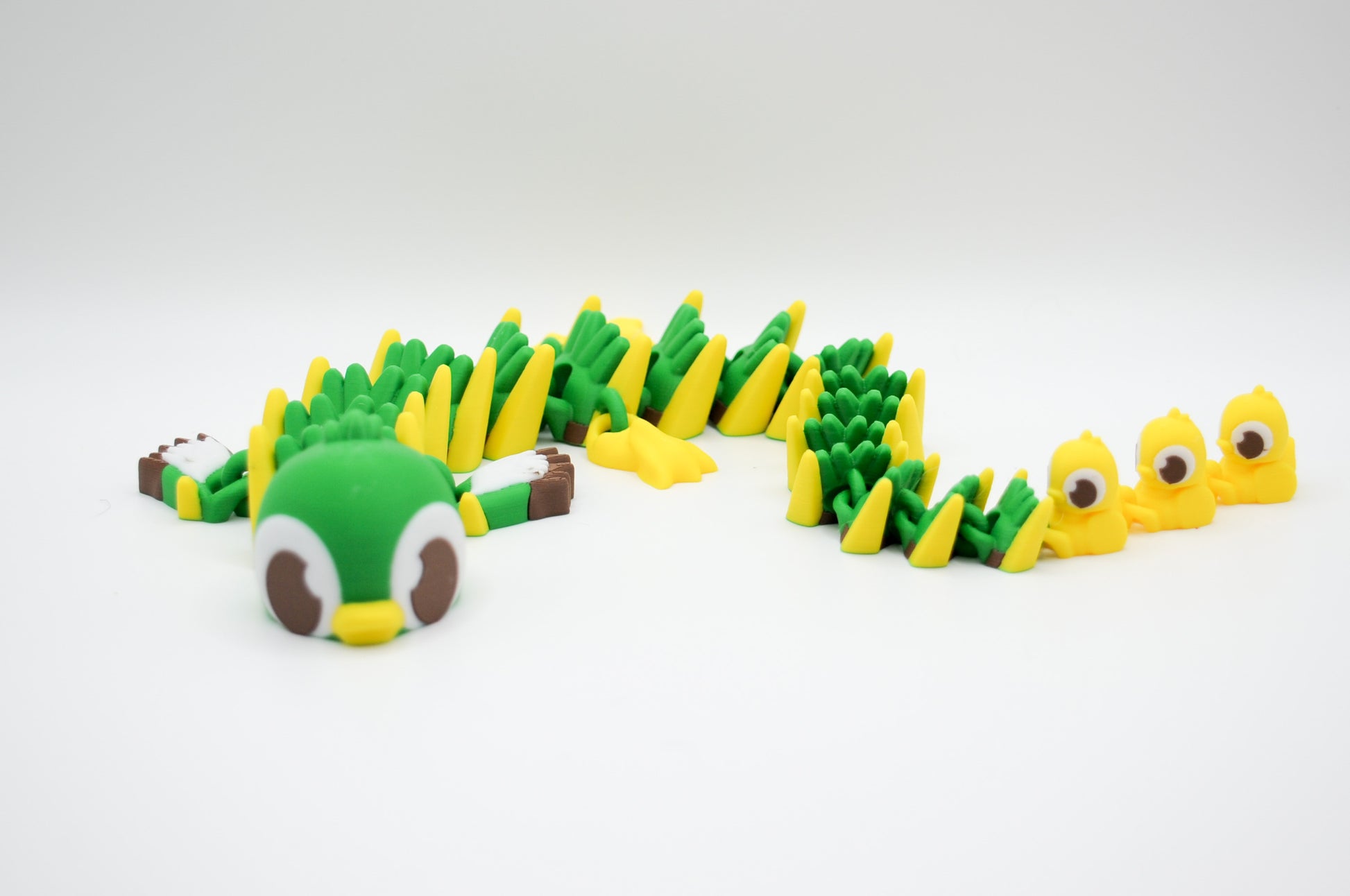 Green and yellow articulated dragon 3D printed figure